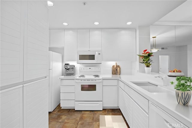 kitchen with white cabinetry, white appliances, sink, and hanging light fixtures