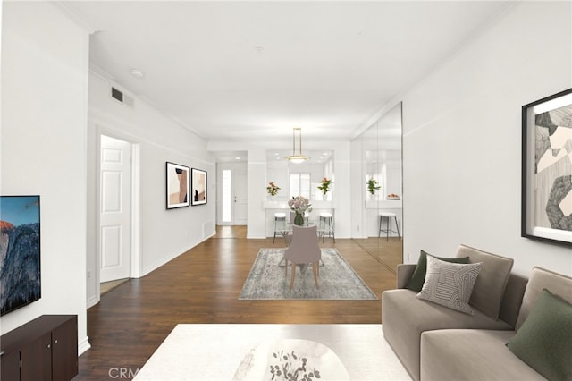 living room with hardwood / wood-style flooring and ornamental molding