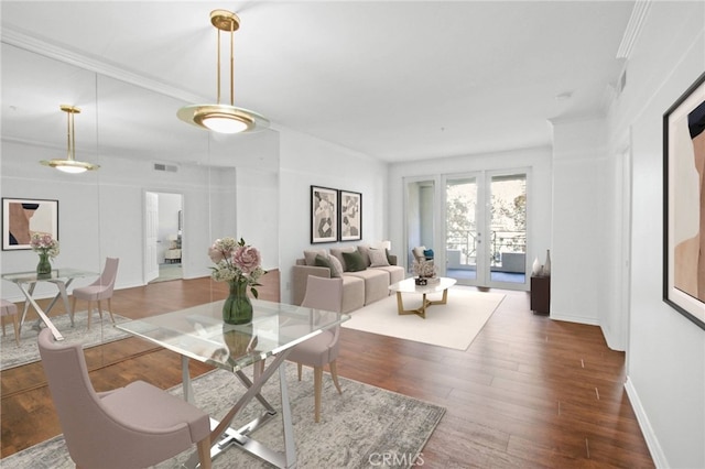 dining area featuring ornamental molding and dark wood-type flooring