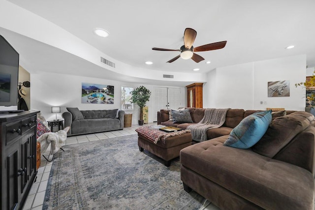 tiled living room featuring french doors and ceiling fan