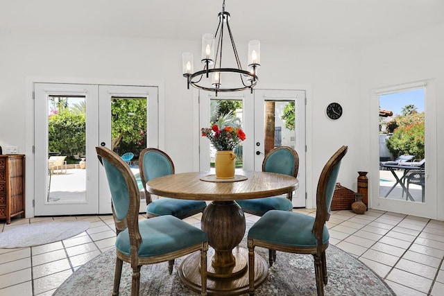 tiled dining space with a notable chandelier and french doors