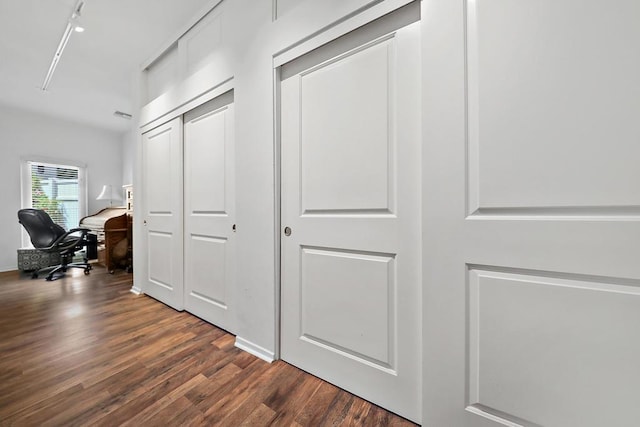 corridor featuring dark wood-type flooring