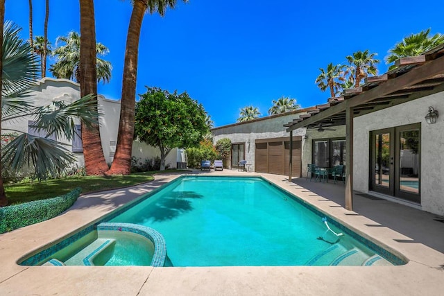 view of pool featuring a patio area, french doors, and an in ground hot tub