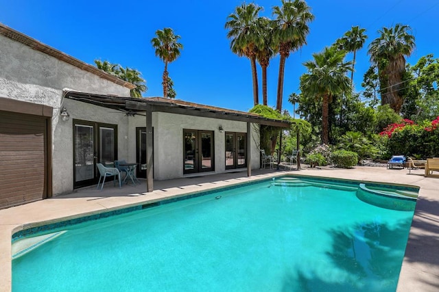 view of pool featuring ceiling fan, a patio, and french doors