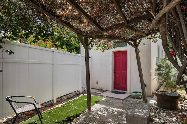 entrance to property with a patio area and a pergola