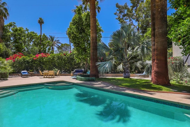 view of pool featuring a patio and an in ground hot tub