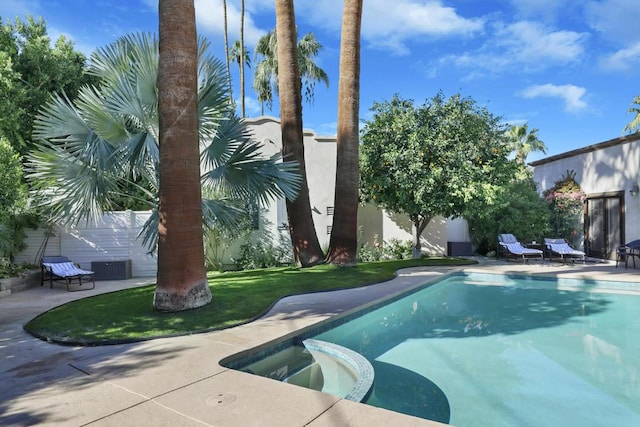 view of swimming pool with a yard, an in ground hot tub, and a patio area