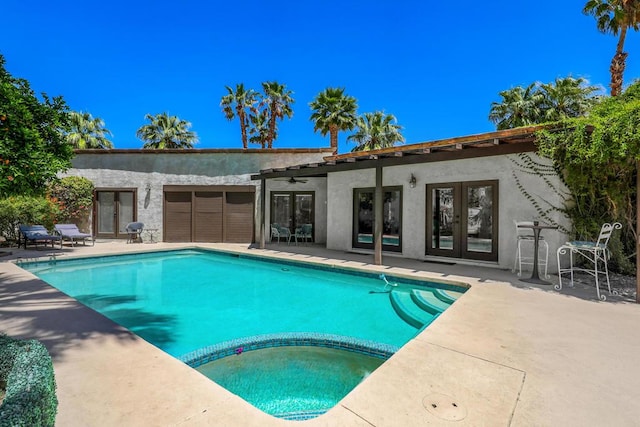 view of swimming pool featuring french doors and a patio area