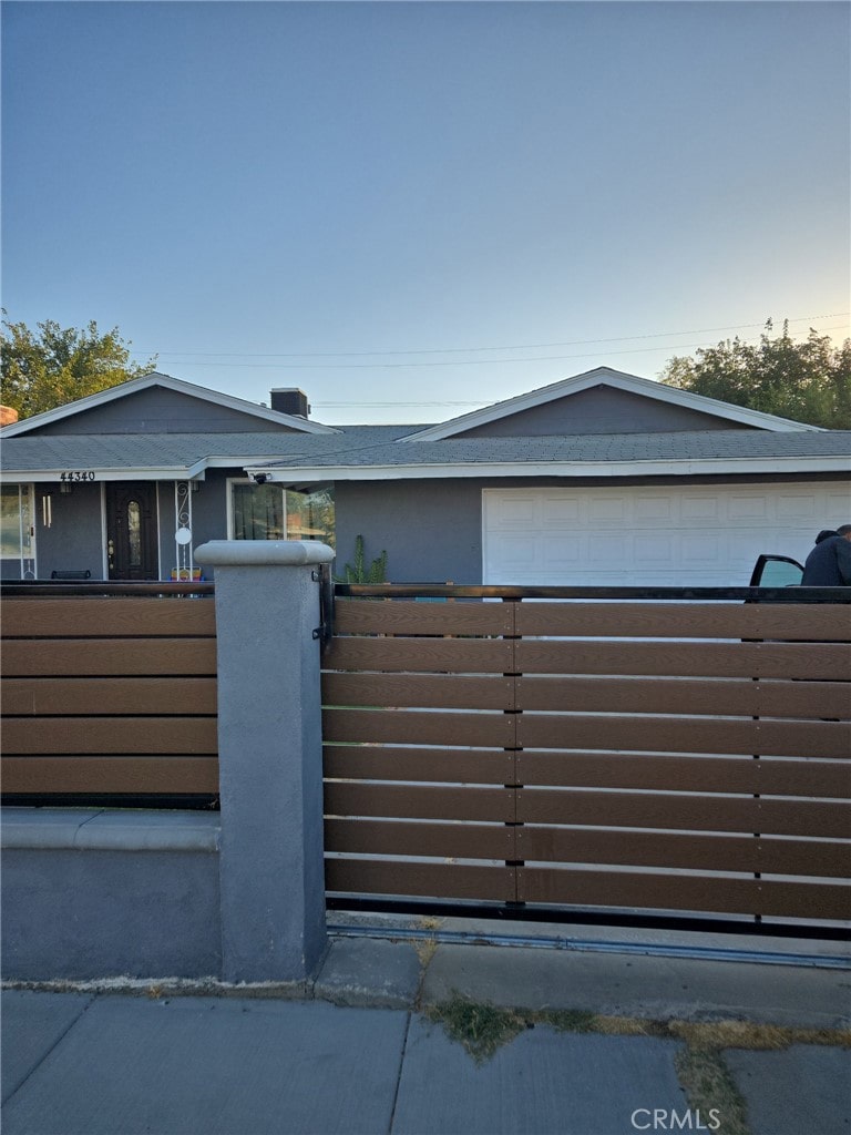 view of gate featuring a garage