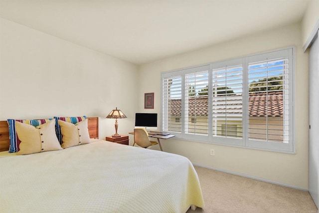 bedroom with carpet flooring and baseboards