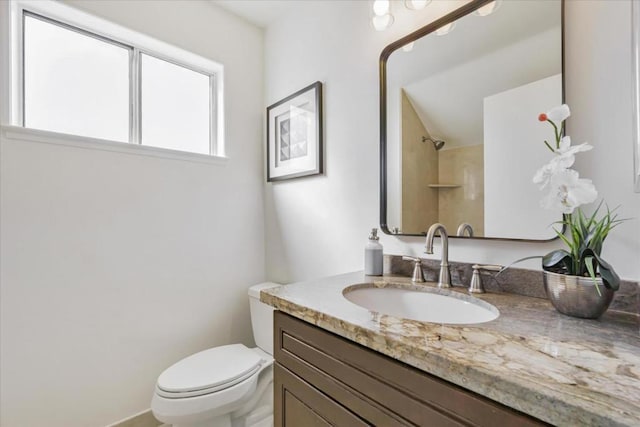 bathroom with vanity, toilet, and walk in shower