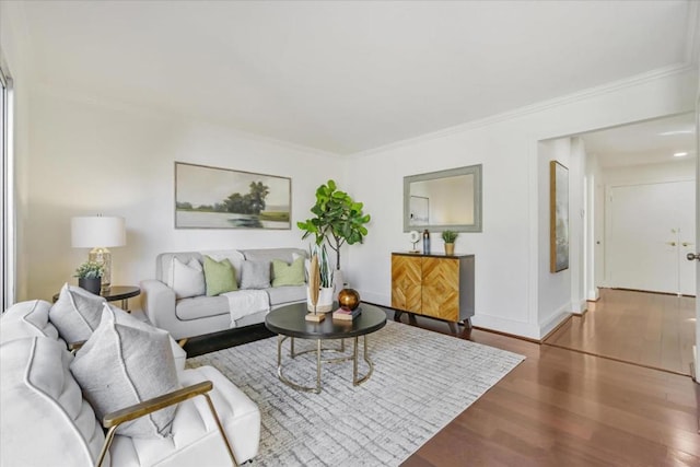 living room with hardwood / wood-style flooring and crown molding