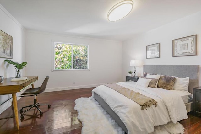 bedroom with crown molding and dark hardwood / wood-style floors