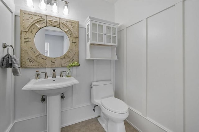 bathroom featuring tile patterned flooring and toilet