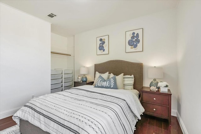 bedroom with dark hardwood / wood-style flooring