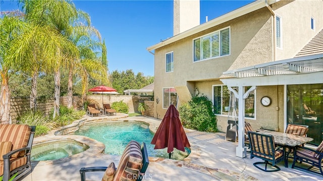 view of pool with an in ground hot tub and a patio