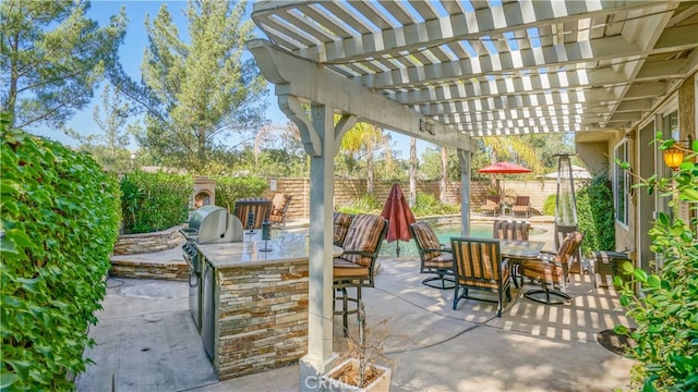 view of patio with a bar, area for grilling, and a pergola