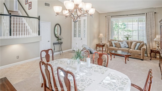 dining space with light tile patterned flooring and a chandelier