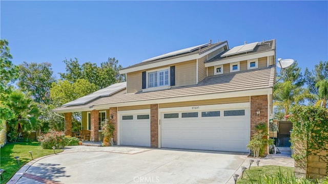 view of front of home featuring solar panels and a garage