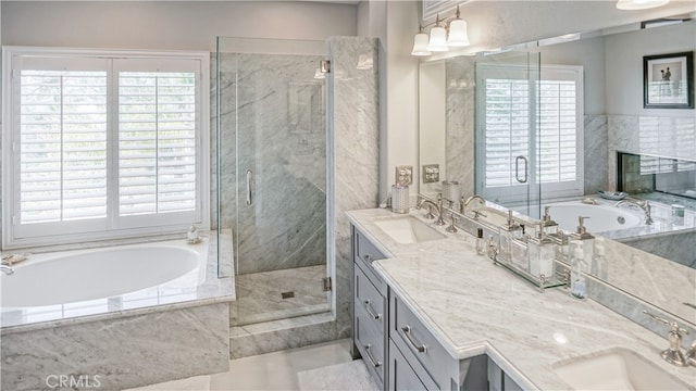 bathroom featuring vanity and shower with separate bathtub