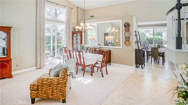 dining room featuring light carpet, a notable chandelier, and high vaulted ceiling