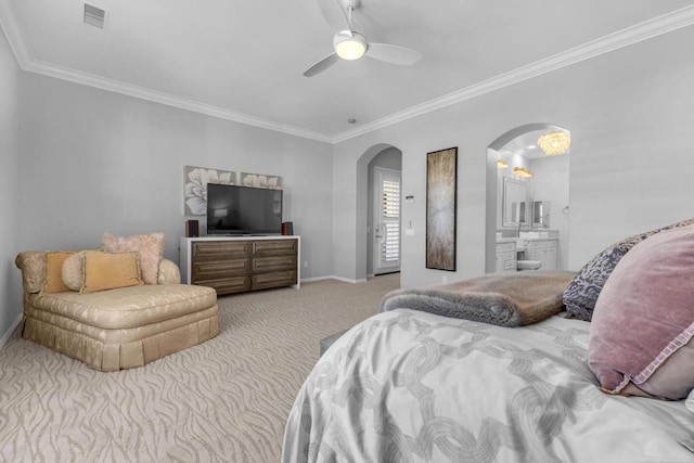 carpeted bedroom featuring connected bathroom, ceiling fan, and ornamental molding