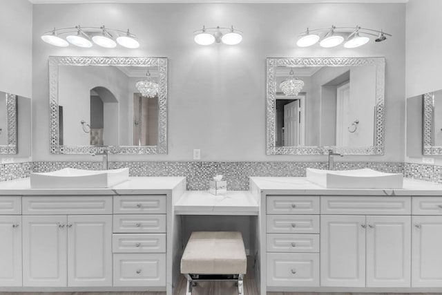 bathroom with decorative backsplash and vanity