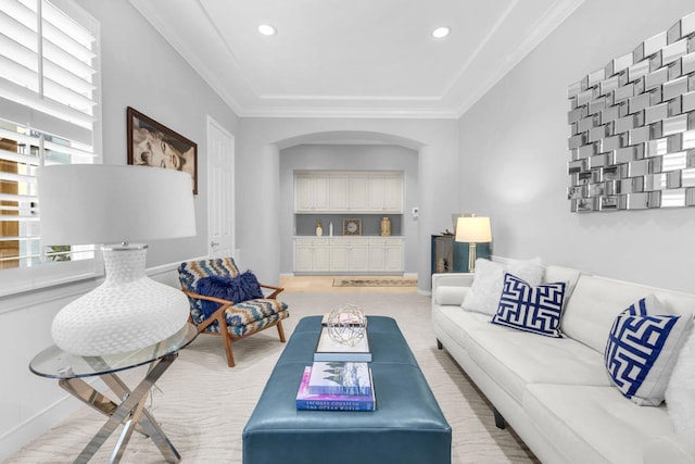 carpeted living room featuring ornamental molding