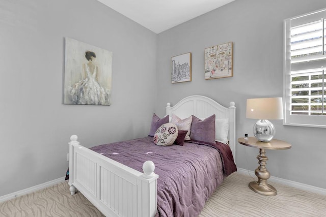 carpeted bedroom featuring multiple windows