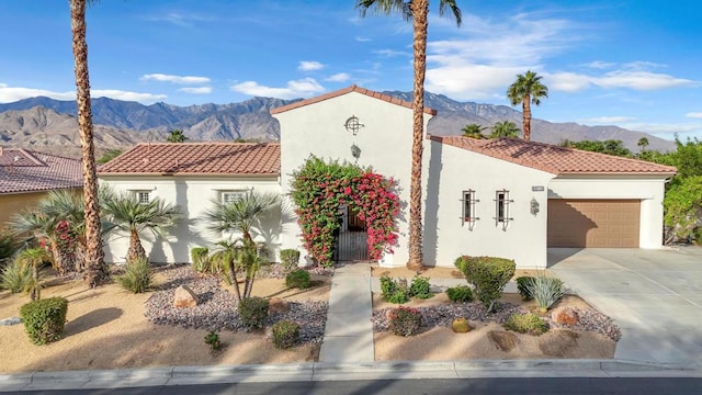 mediterranean / spanish-style house featuring a mountain view and a garage