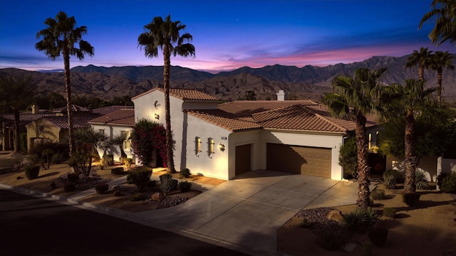 mediterranean / spanish house featuring a mountain view and a garage