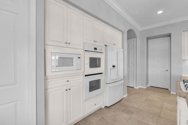 kitchen featuring white appliances, white cabinetry, ornamental molding, and light tile patterned flooring