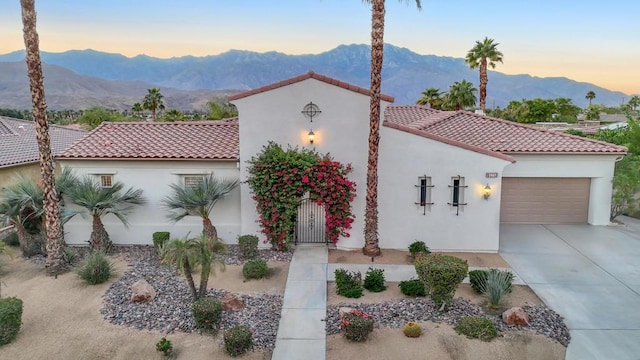 mediterranean / spanish-style home featuring a mountain view and a garage