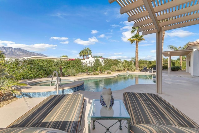 view of swimming pool with a pergola, an in ground hot tub, a mountain view, and a patio