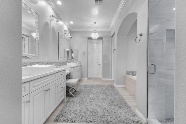 bathroom featuring shower with separate bathtub, vanity, and crown molding