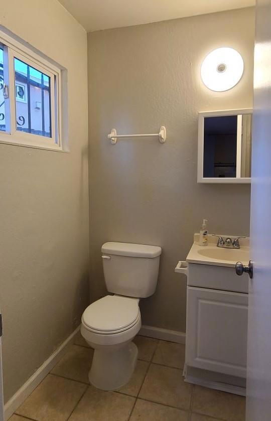 bathroom with tile patterned floors, toilet, and vanity