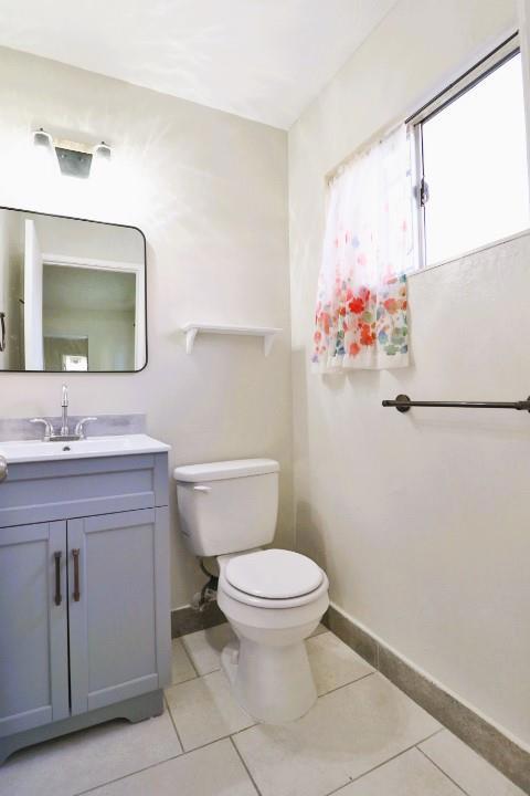 bathroom featuring tile patterned floors, toilet, and vanity