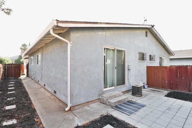 back of property with a patio and cooling unit