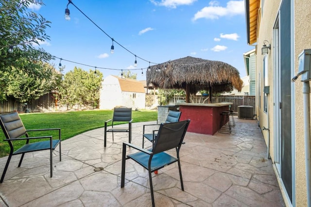 view of patio featuring cooling unit and an outdoor bar