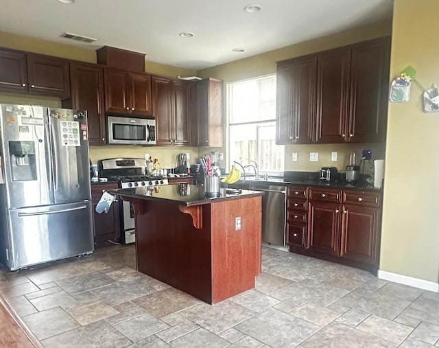 kitchen featuring a breakfast bar, a center island, and stainless steel appliances