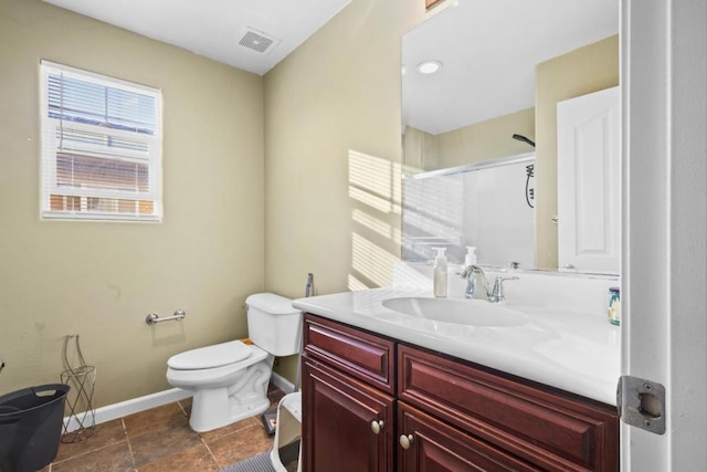 bathroom featuring vanity, toilet, and walk in shower