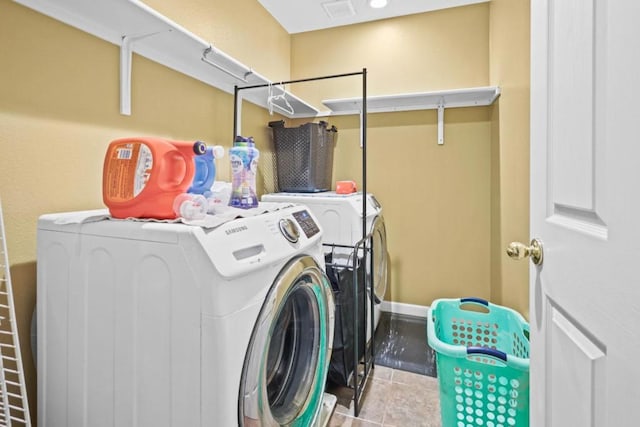 washroom with light tile patterned floors and washing machine and clothes dryer