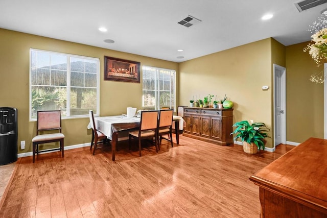 dining area with light hardwood / wood-style flooring and a wealth of natural light