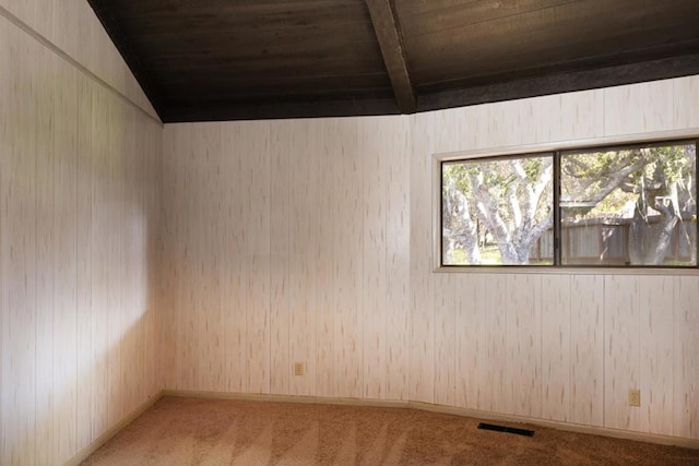 carpeted empty room featuring lofted ceiling with beams and wooden ceiling