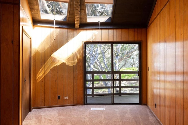 interior space with plenty of natural light, wood walls, and carpet