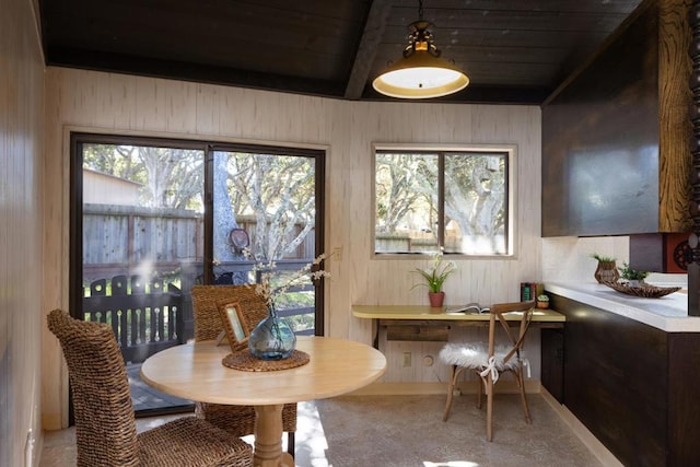 dining room featuring wooden ceiling and beamed ceiling