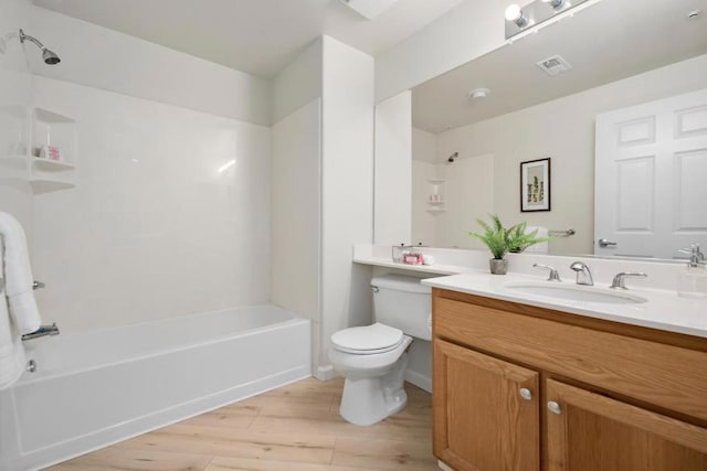 full bathroom with shower / bath combination, hardwood / wood-style floors, toilet, and vanity