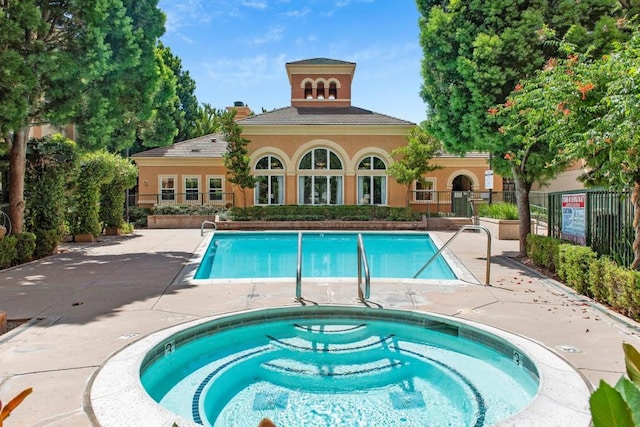 view of pool with a community hot tub