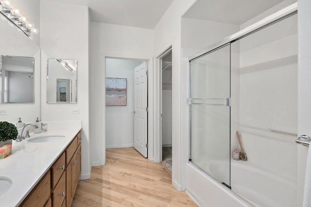 bathroom with vanity, shower / bath combination with glass door, and wood-type flooring