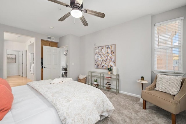 carpeted bedroom featuring ceiling fan and ensuite bathroom